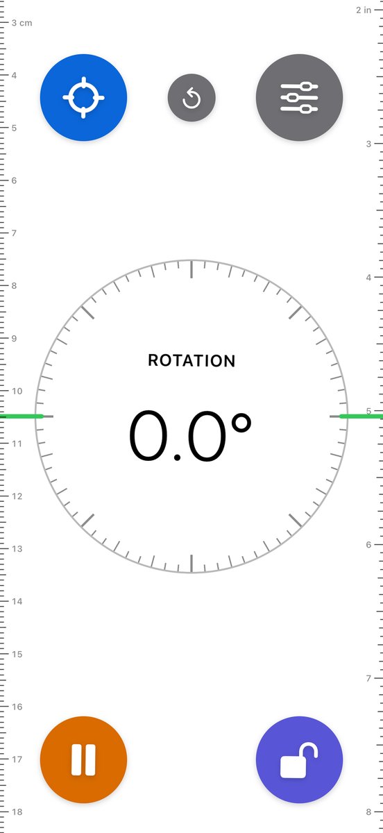 Edge level with a ruler down each side, centimeters on the left and inches on the right, both slid down the screen. The reading is Rotation 0.0 degrees. A small reset button sits between Target and Settings.