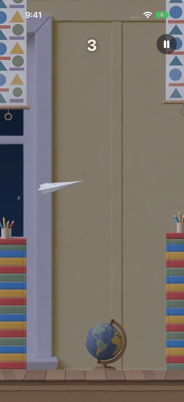 Classroom: a white paper airplane flies between stacks of books and hanging banners of paper shapes, with a globe on the floor.